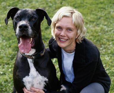 woman holding black great dane